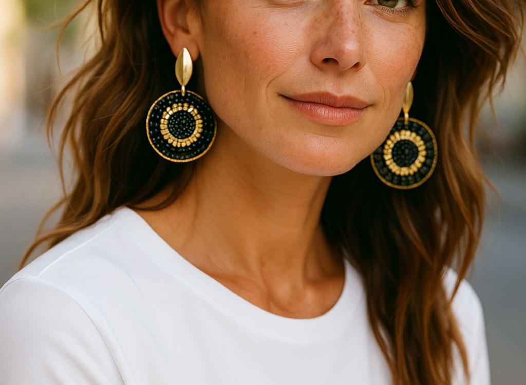wearing round earrings with black and gold details