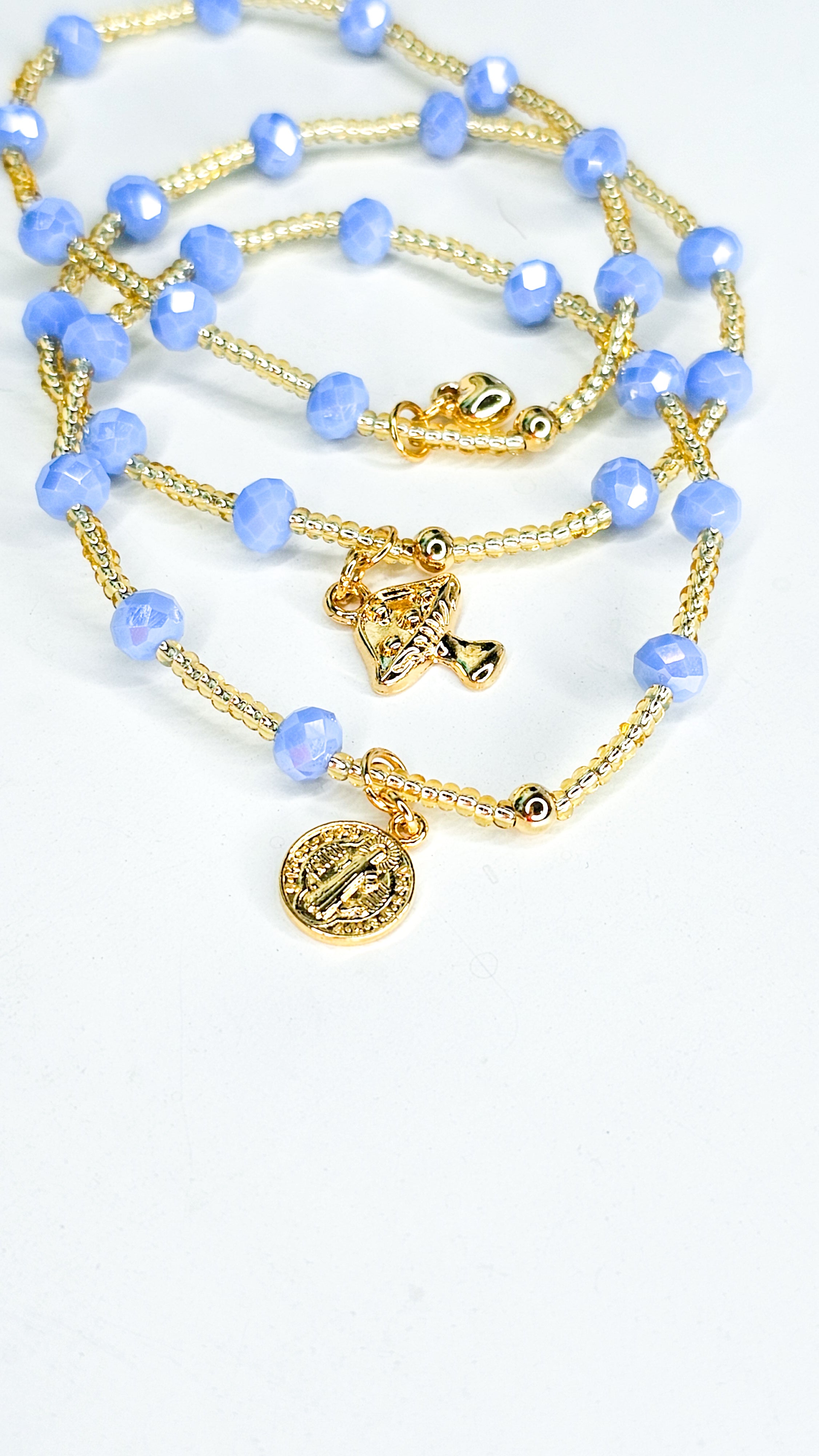 Necklace with blue beads and gold accents on a white background
