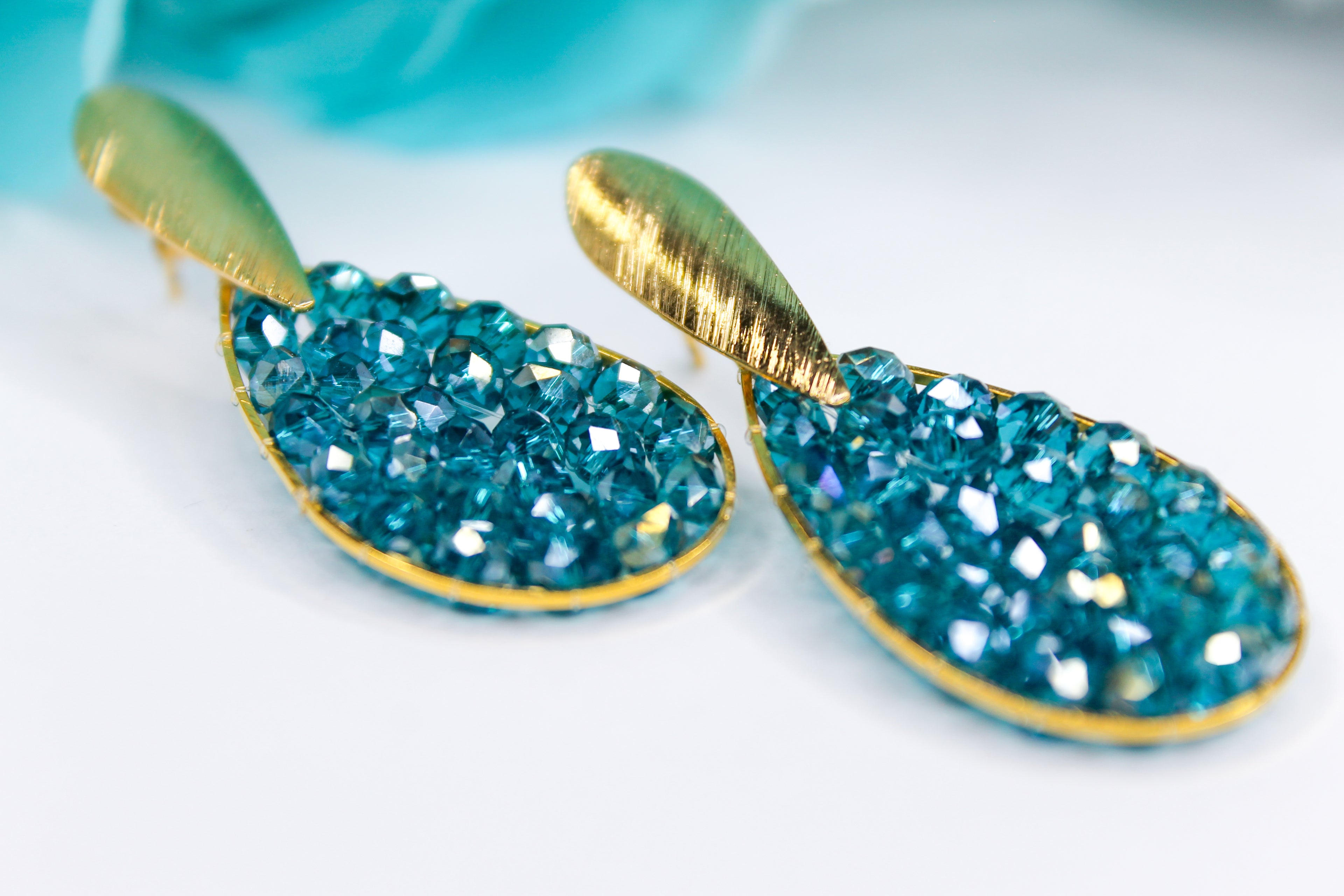Teal crystal earrings with gold accents