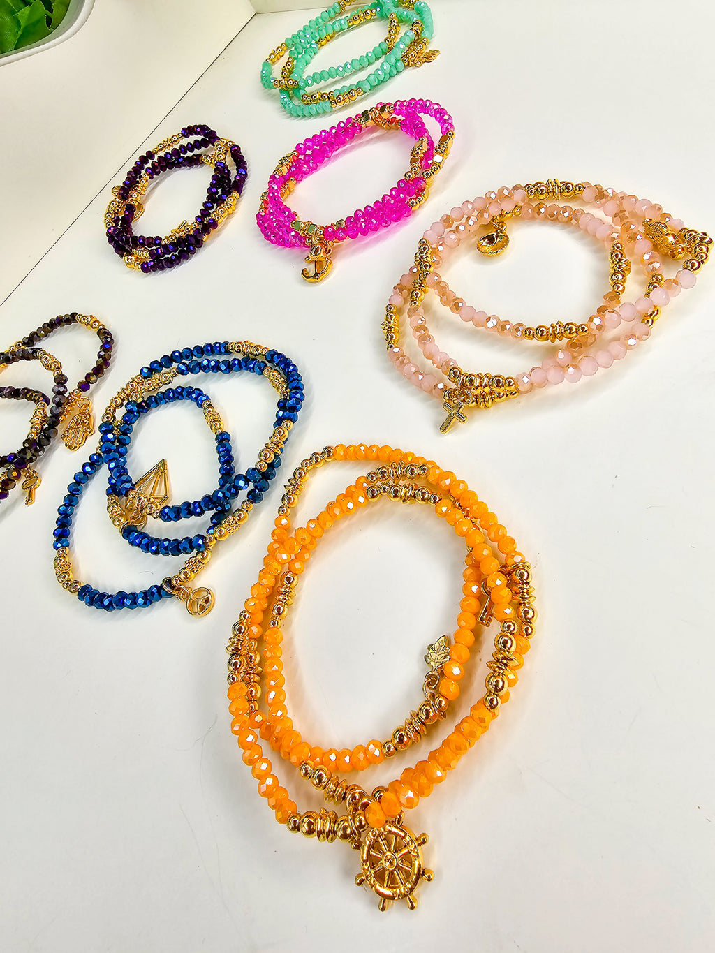 Colorful beaded bracelets with gold accents 