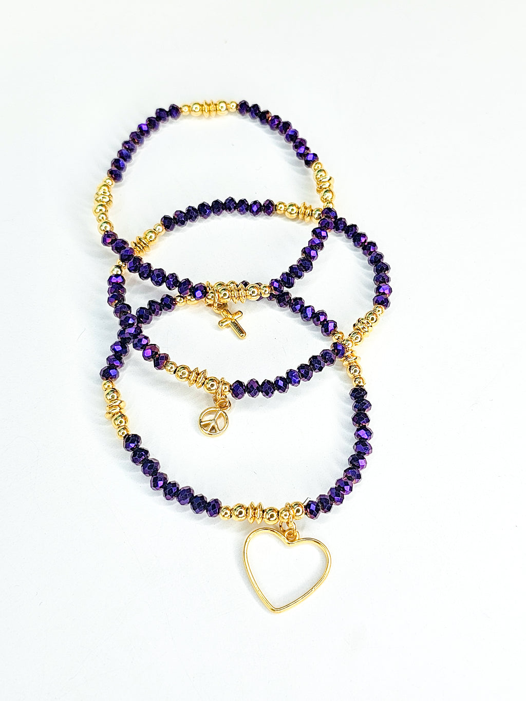 Set of purple beaded bracelets with gold accents 