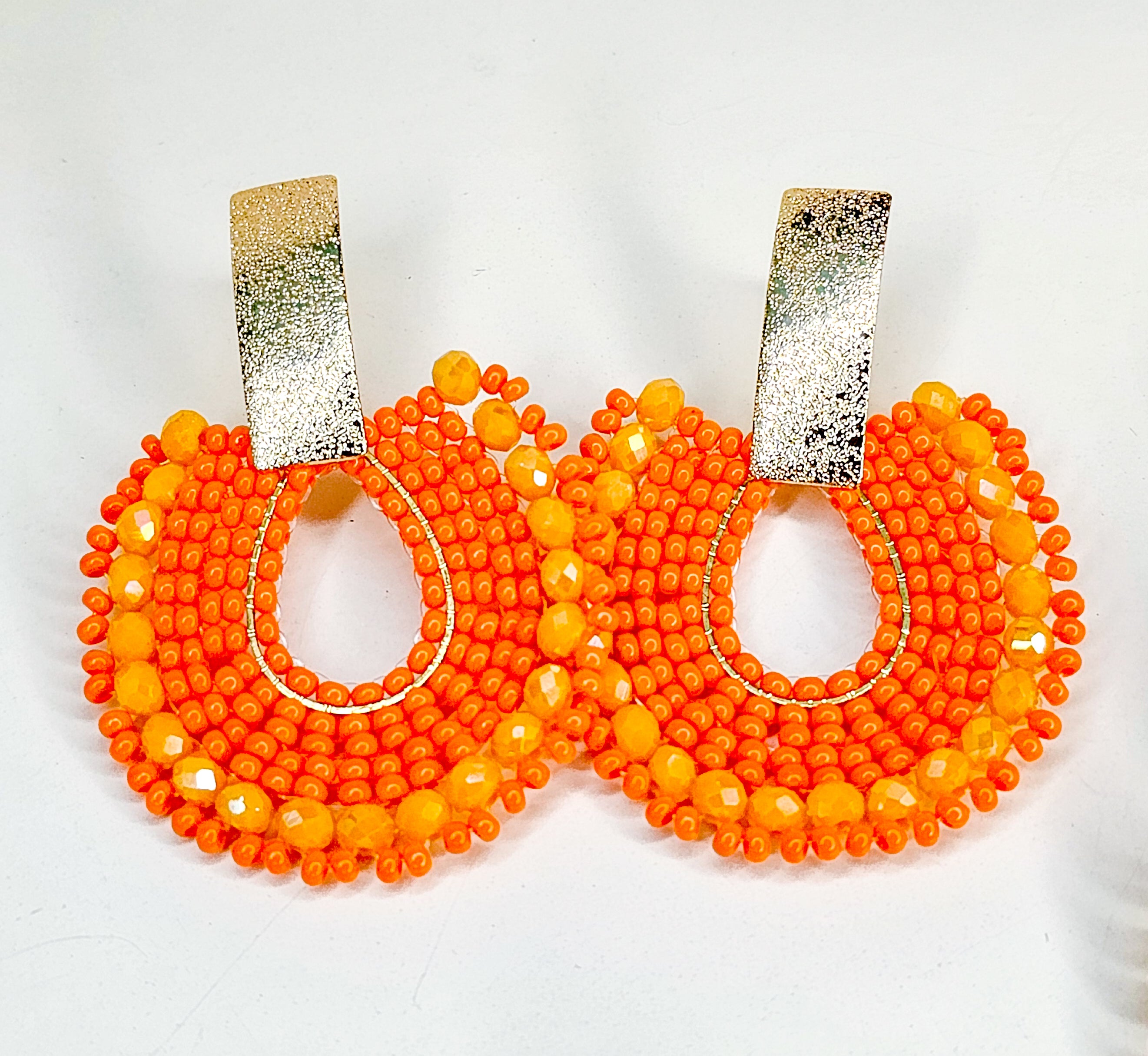 Pair of orange beaded earrings with gold accents