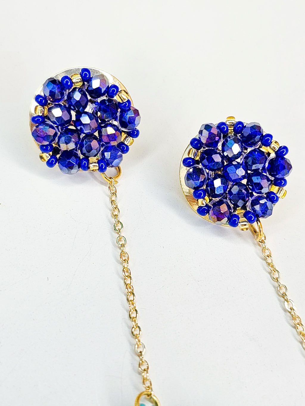 Pair of blue beaded earrings with gold chains 