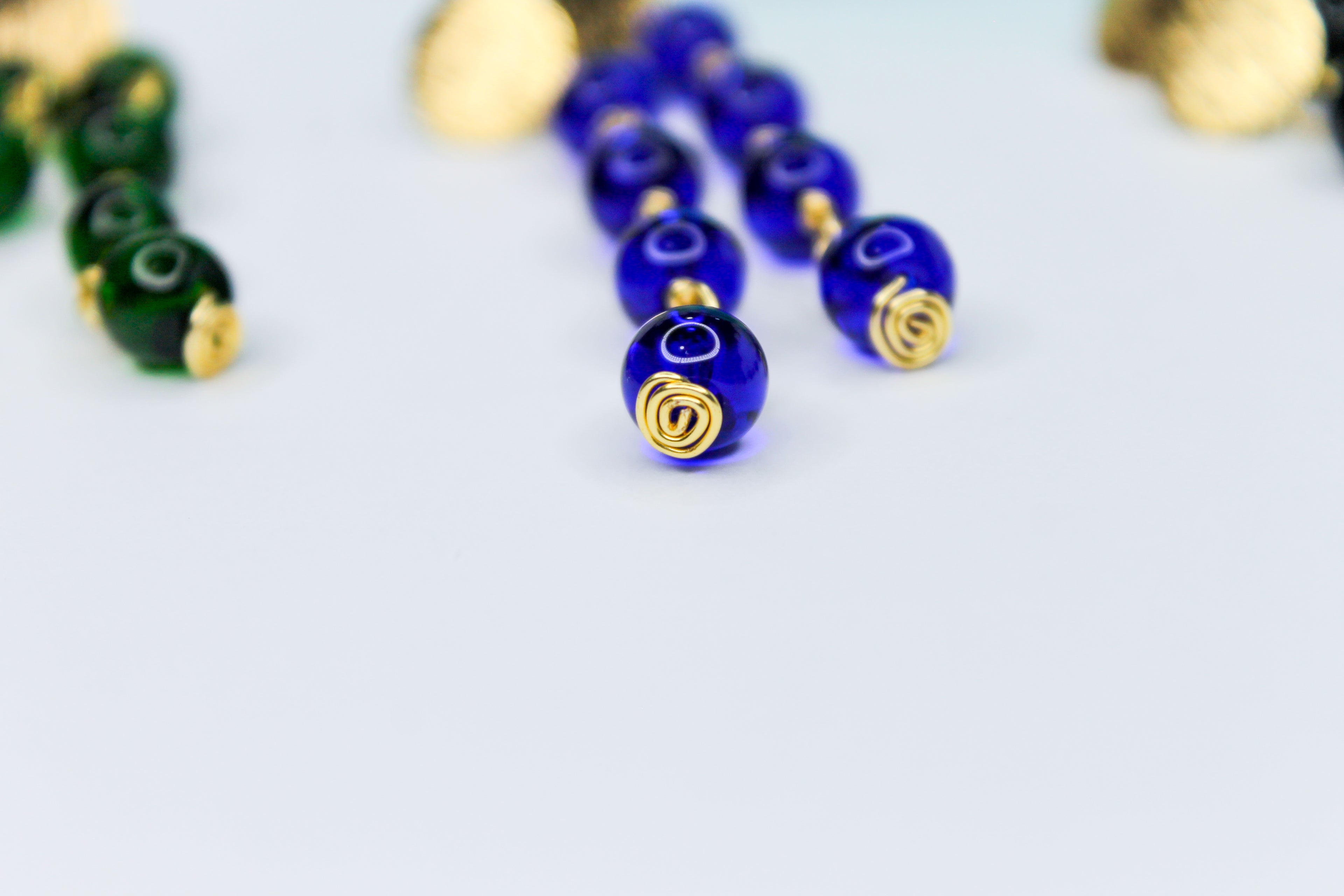 Close-up of blue beads with gold accents 