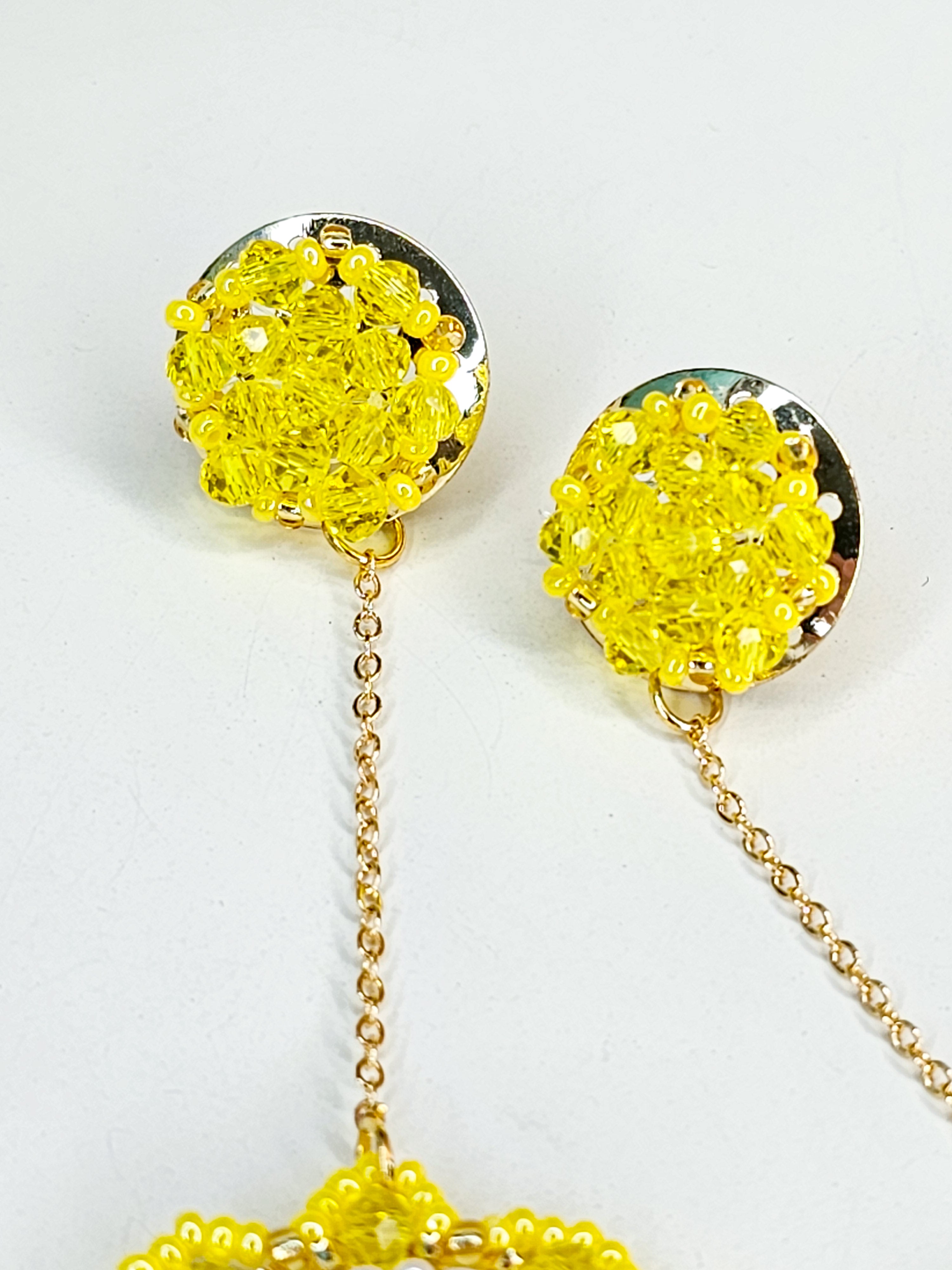 Pair of yellow floral earrings with gold chains